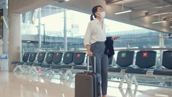 asian business girl walk with luggage to terminal gate at international airport for flight.
