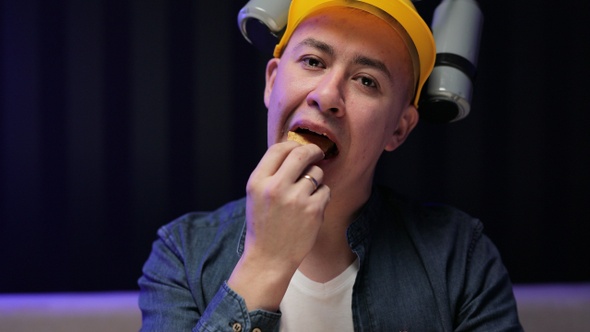 The Guy With Beer Helmet on the Head Sits on the Couch Eats Chips and Watches the TV alt