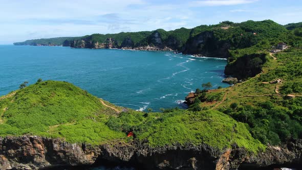 Sheer cliffs and azure ocean aerial panorama, Kesirat, Yogyakarta Indonesia alt