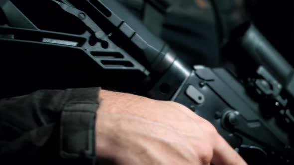 Soldier of the Russian Federation in a camouflage uniform holds a modern Kalashnikov assault rifle alt