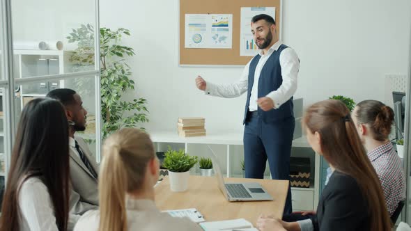 Ambitious Businessman Making Presentation Then Doing Highfive with Group of Colleagues in Office alt