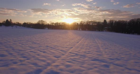 Drone sunset in snowy campain, beautiful winter sunset landscape