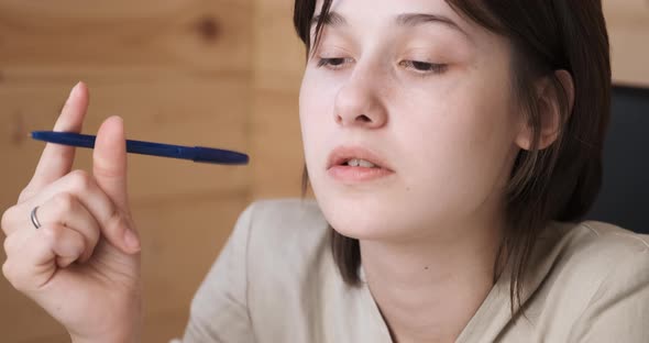 Thoughtful Young Woman Nervously Twists a Pencil Make Difficult Choice