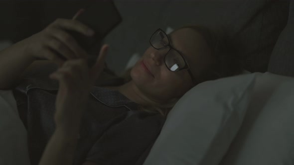 Woman Using Smartphone at Night