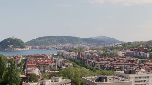 Majestic rooftops of San Sebastian city with bay view, aerial cinematic view alt