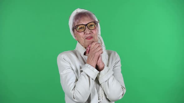 Portrait of Old Stylish Woman Is Looking with Tenderness with Folded Arms in Front of Her Isolated alt