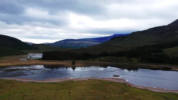 Tilt-up drone shot of a scottish river valley. Aerial video shot by a drone in Scotland, highland la alt