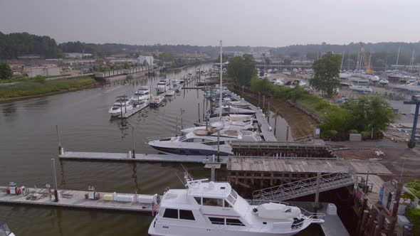 Flying Over Boats Docked at Marina in Glen Cove on a Cloudy Day alt