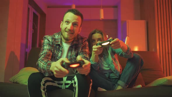 Emotional Diverse Gamers are Holding Joysticks and Competition in Intense Video Game on Gaming alt