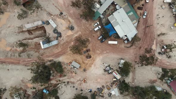 A high view looking down at a old pub and discarded mining equipment in the Australian outback of a alt