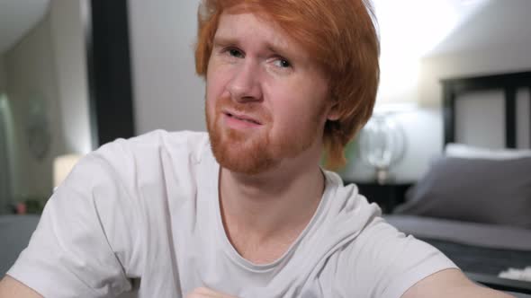 Reacting to Loss Casually Sitting Redhead Man alt