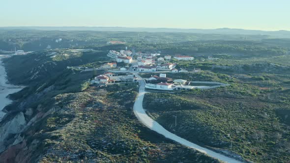 Calm Andalusian village waking up during sunrise with coastline alt