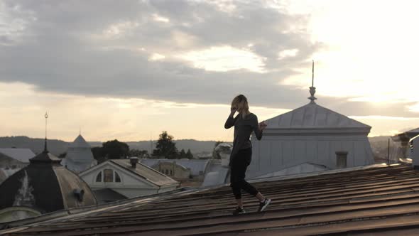 Woman dancing on the rooftop alt