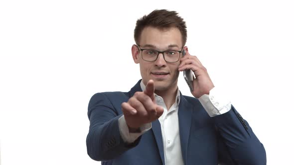 Closeup of Handsome Successful Businessman in Blue Suit and Glasses Talking on Mobile Phone and alt