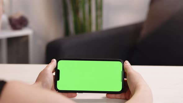 Woman Using Phone With Green Mock-up Screen Chroma Key Surfing Internet Watching Content Videos Blog