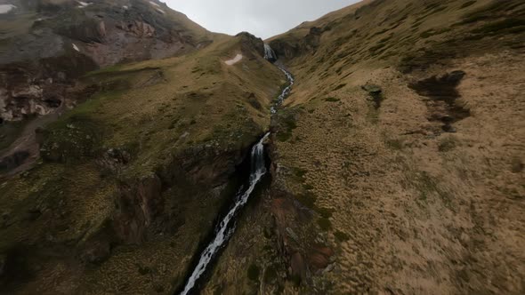 Fast FPV Drone Shot Up Along the Mountain Dew Towards to the Big Waterfall alt