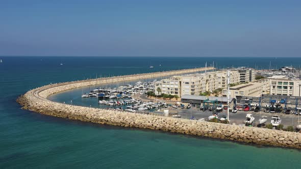 Small waves from the Mediterranean sea calmly roll out against the long breakwater that protects the alt
