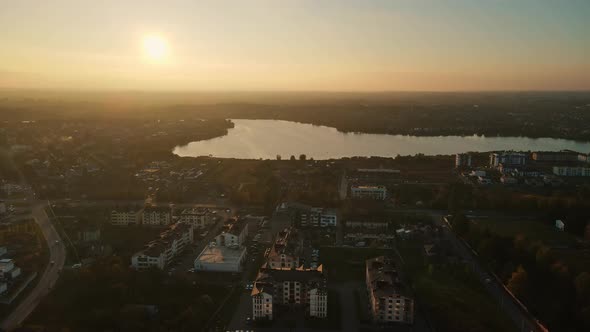 Sunset On The Background Of The Evening City And Lake
