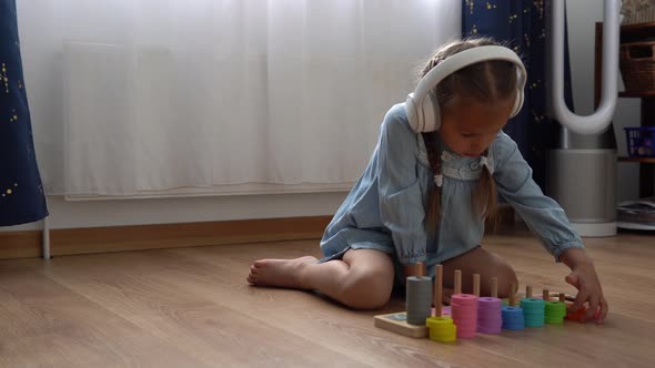 Happy Little Preschool Toothless Girl Playing With Colored Wooden Toy