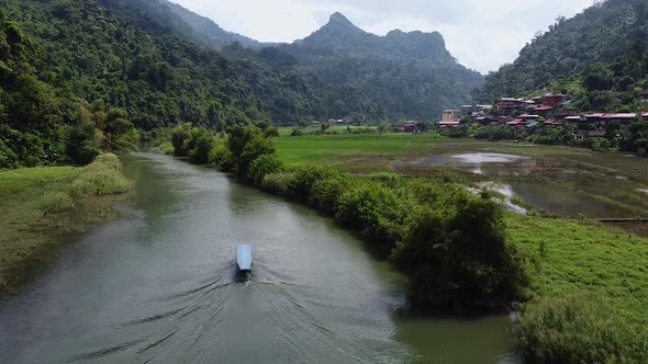 Stunning Aerial View of a Tourists Boat Sailing Along River at Sunset alt
