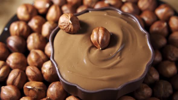 Hazelnuts Falling Into Liquid Chocolate in Slow Motion