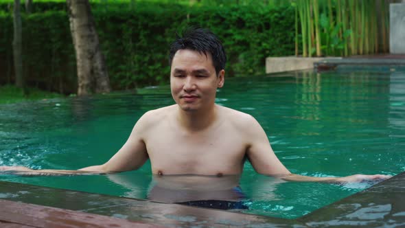 relaxed young man in swimming pool