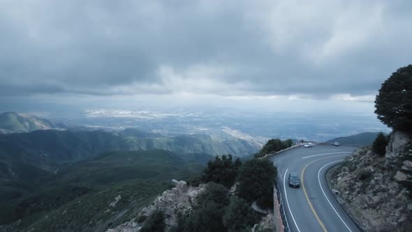 Aerial shot of the valley, drone flies over the winding road near Twin Peaks, California, USA alt