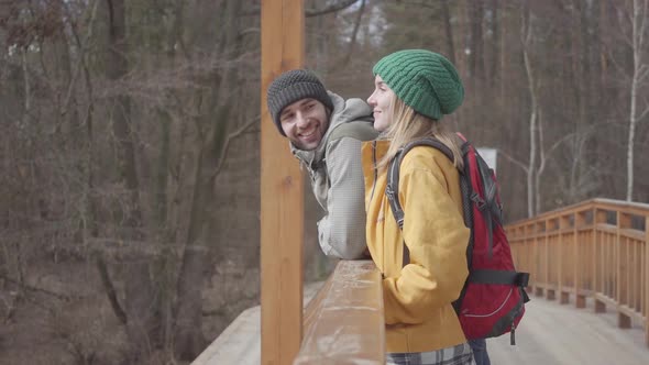 Portrait of the Young Peoples Standing on the Bridge with Backpacks on Their Backs. Bearded Man and alt