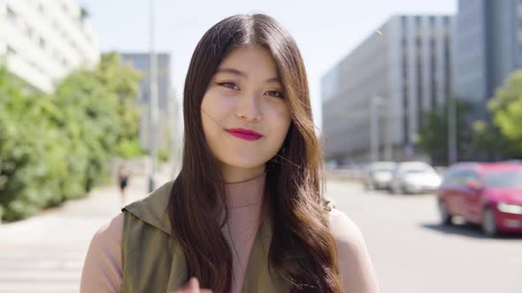 Young Asian Woman Smiles Camera Street Urban Area  Closeup alt