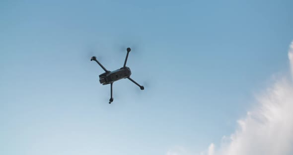 Takeoff Drone Flies on Bright Blue Sky Background. Modern Technologies for Shooting Photos and alt