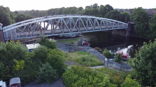 Aerial view peaceful Manchester ship canal swing bridge Warrington England low angle left dolly alt