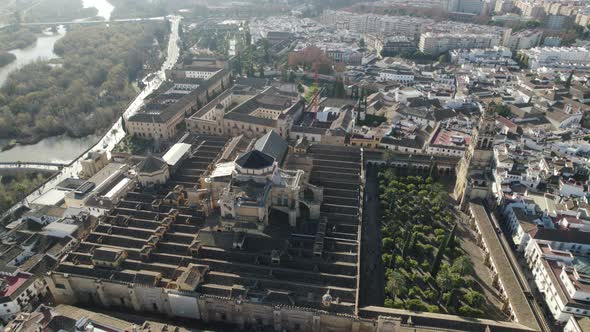 Scenic view Of Mosque Cathedral of Cordoba with Guadalquivir riverside, Descending tilt up