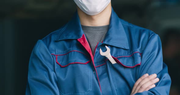 Car Mechanic Posing in Protective Medical Mask, Standing at Repair Workshop alt