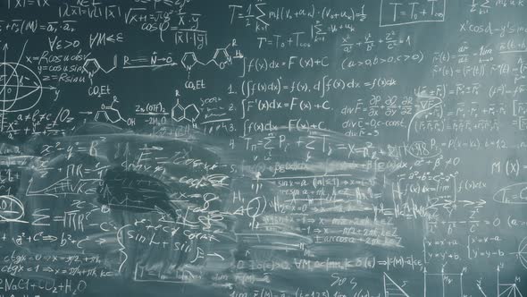 Zoom-out Time-lapse of Clever Young Professor Writing Formulas on Chalkboard alt
