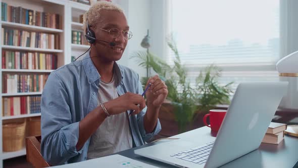 Young African American Business Man Discusses Company Affairs Through Headset alt
