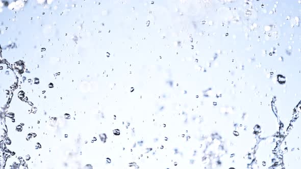 Super Slow Motion Shot of Water Splash on Light Blue Background at 1000Fps alt