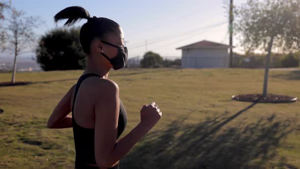 Mixed ethnicity woman working out in the park alt