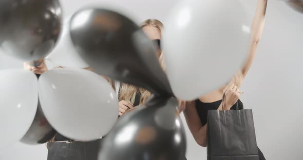 Happy Women with Air Balloons Shopping