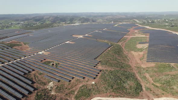 Aerial - vast solar farm in countryside of Lagos, Portugal; green energy