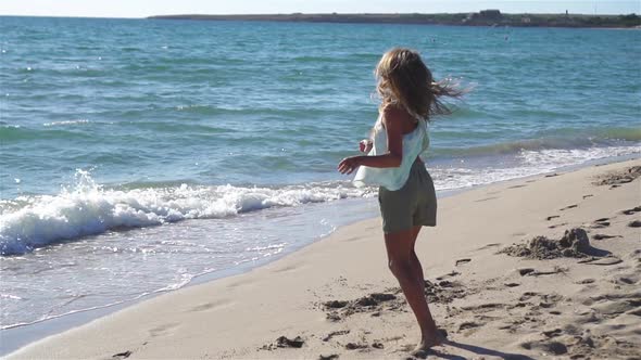 Adorable Little Girl at Beach During Summer Vacation