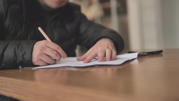 Working with Documents Inside the City Cafe in Winter alt