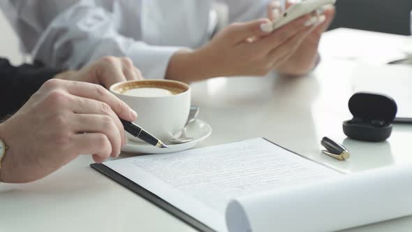 Business Meeting of Men and Women at the Table Closeup of the Hands of Business People Without a alt