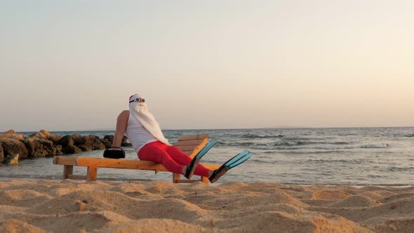 Funny Santa Claus Sunbathes Santa In Sunglasses And Flippers Is