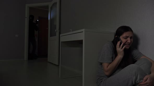 Woman Calls Police for Rescue and Safety Hiding Behind Desk alt