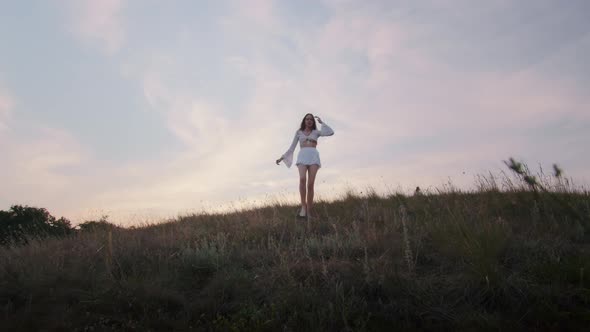 Happy Young Woman Enjoying the Sunset Wearing Traditional Ukrainian Clothes alt