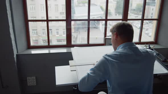 Young architect at work by the window alt