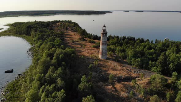 Light house on little island, aerial shot, calm lake waters around