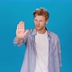 Serious Redhead Man Stretches Out Hand Showing Stop Gesture - VideoHive Item for Sale