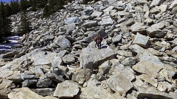 Aerial of Girlfriend and Boyfriend Standing on Boulder alt