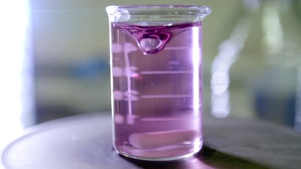 Glass Beaker on Top of a Magnetic Laboratory Stirrer. alt